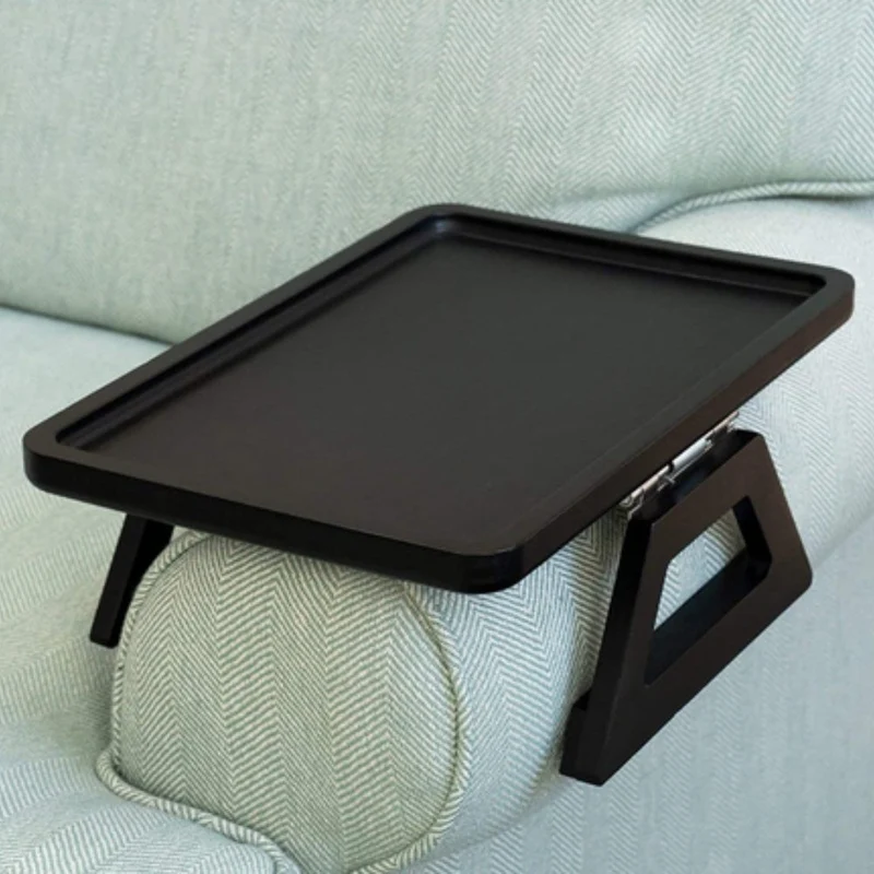 Adjustable table that fits over the armrest for sofa and armchair